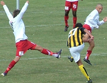 Mikail Anli, Brønshøj, sparker hårdt mellem to sprællende forsvarere fra Lolland Falster i kampen Brønshøj-LFA 29. august 2009 (foto: S. Lillie)